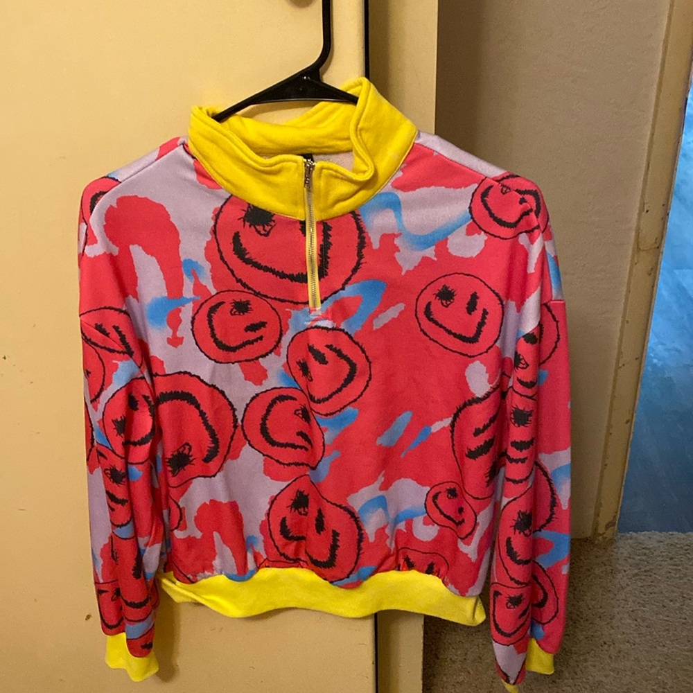 Pink, yellow, and blue smiley face sweater